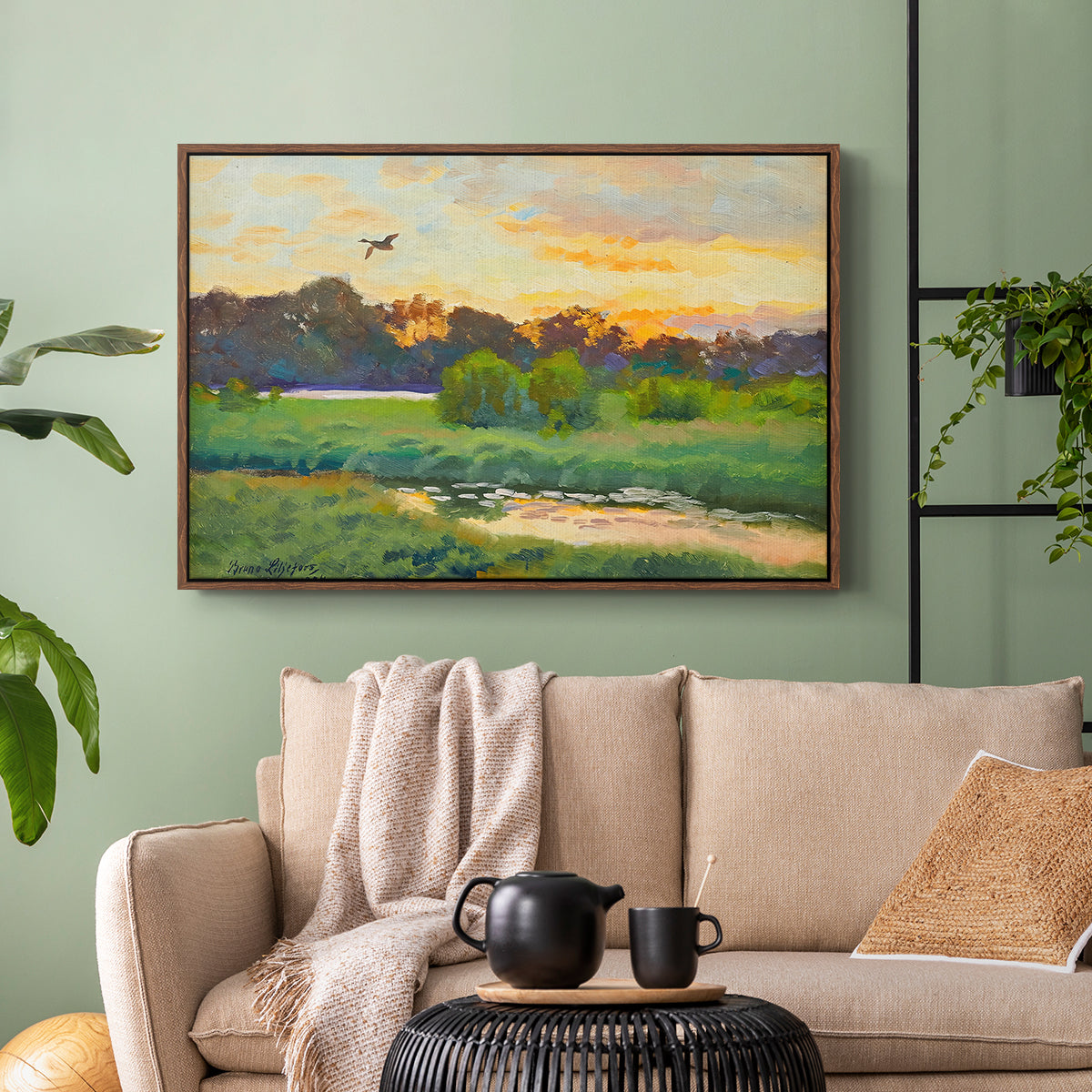 Walnut floater framed canvas featuring a lone duck flying over a marsh at golden hour, displayed above a sofa in a modern living room.
