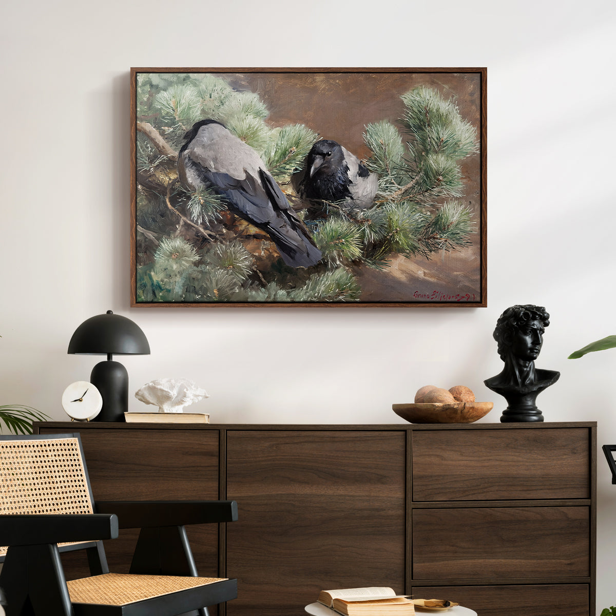 Hooded Crows (Kråkor), 1891 by Bruno Liljefors displayed in a walnut floater framed canvas above a dark wood credenza in an entryway.