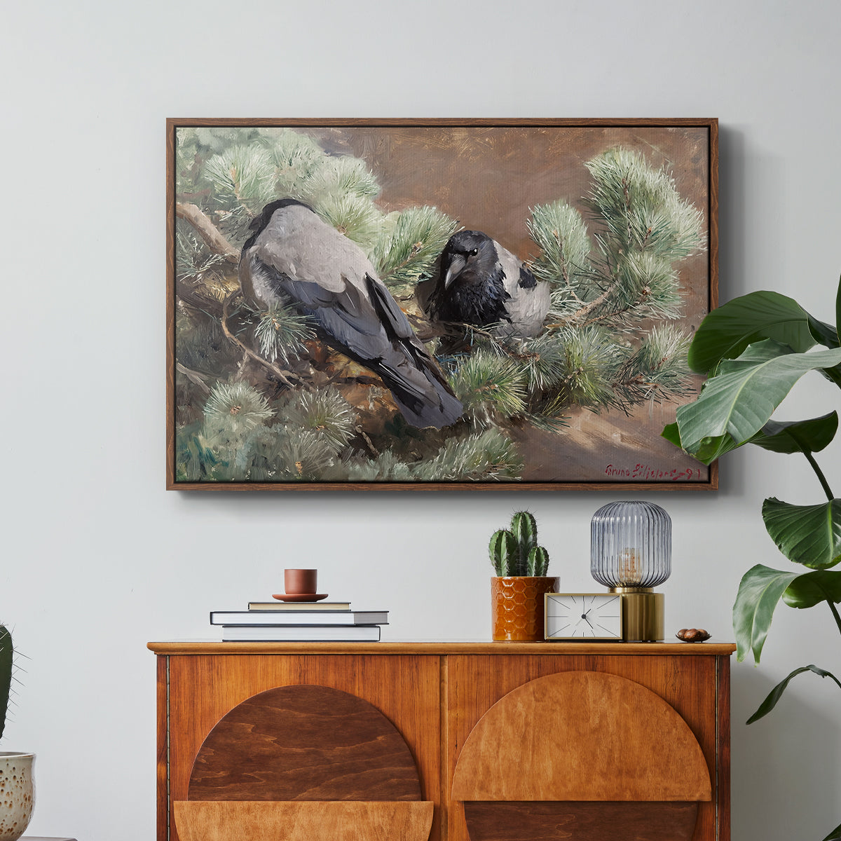 Hooded Crows (Kråkor), 1891 by Bruno Liljefors in a walnut floater framed canvas featuring two crows perched on ground among grass and earth tones, displayed above a wood console cabinet.