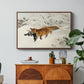 Fox in Snow Landscape, 1900 by Bruno Liljefors in a walnut floater framed canvas featuring a fox running across snowy landscape with sparse vegetation, displayed above a wood console cabinet.