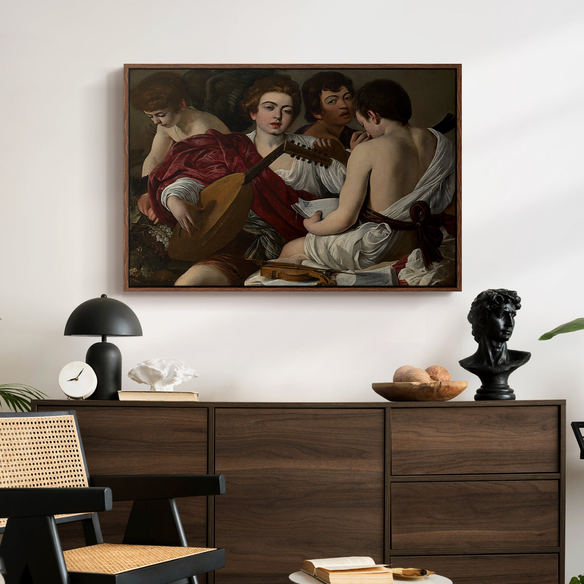 The Musicians, c. 1595 by Caravaggio displayed in a walnut floater framed canvas above a dark wood credenza in an entryway.