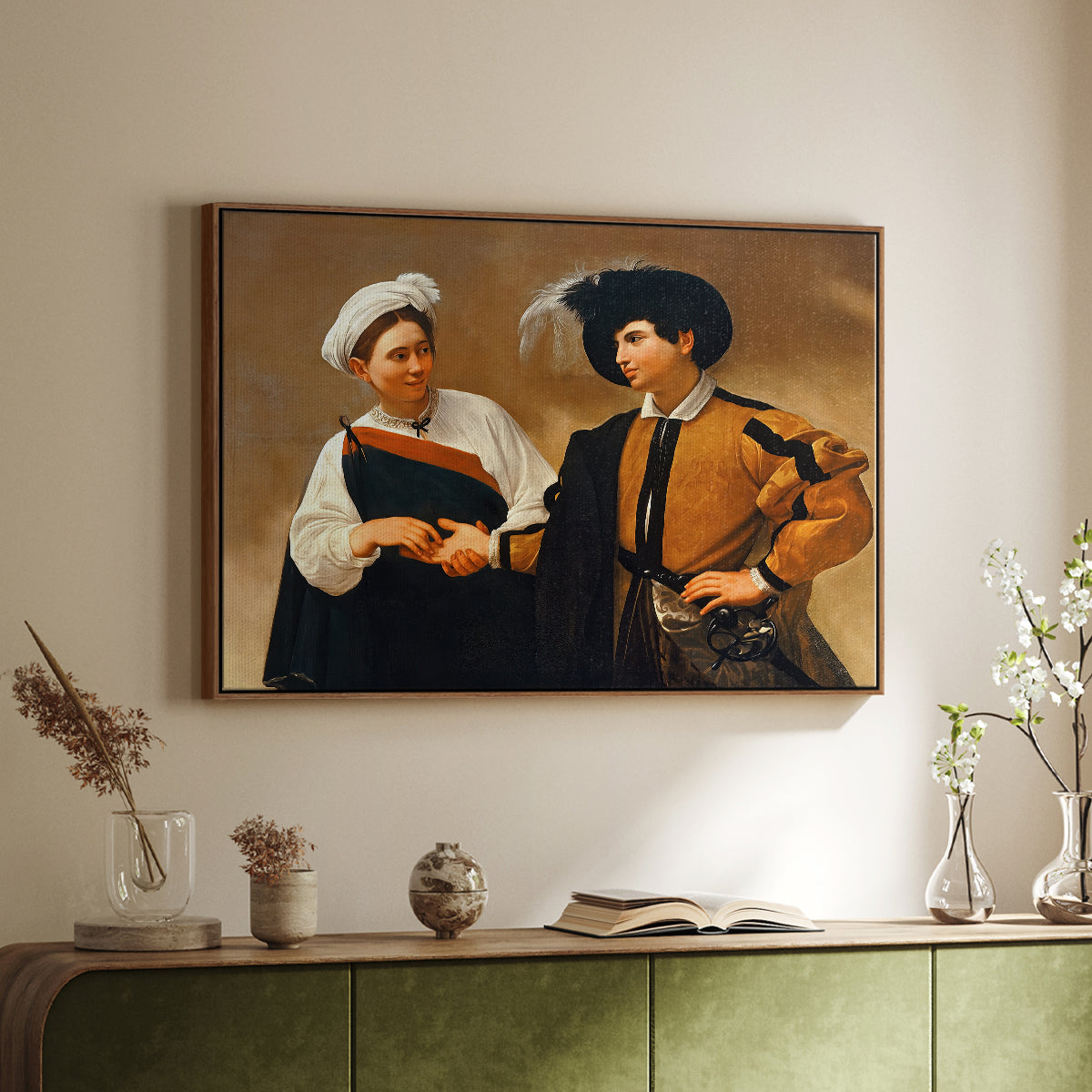 Walnut floater framed canvas of The Fortune Teller (Capitoline Version), c. 1599 by Caravaggio, featuring a fortune teller tricking young man during palm reading above a sideboard in a softly lit hallway.