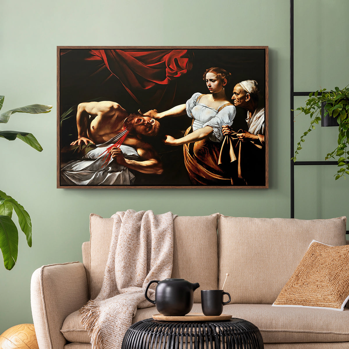 Walnut floater framed canvas featuring a violent religious narrative with strong contrast of light and shadow, displayed above a sofa in a modern living room.