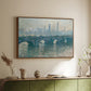 Walnut floater framed canvas of Waterloo Bridge, Gray Weather, 1900 by Claude Monet, featuring an impressionist cityscape with bridge fading into fog over water above a sideboard in a softly lit hallway.