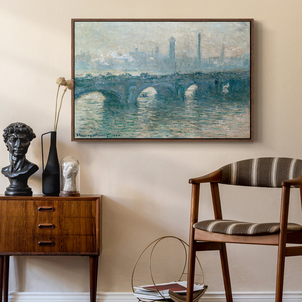 Waterloo Bridge, Gray Weather, 1900 by Claude Monet as a walnut floater framed canvas featuring a soft-toned river scene with bridge and muted skyline, styled above a mid-century console in a contemporary living area.