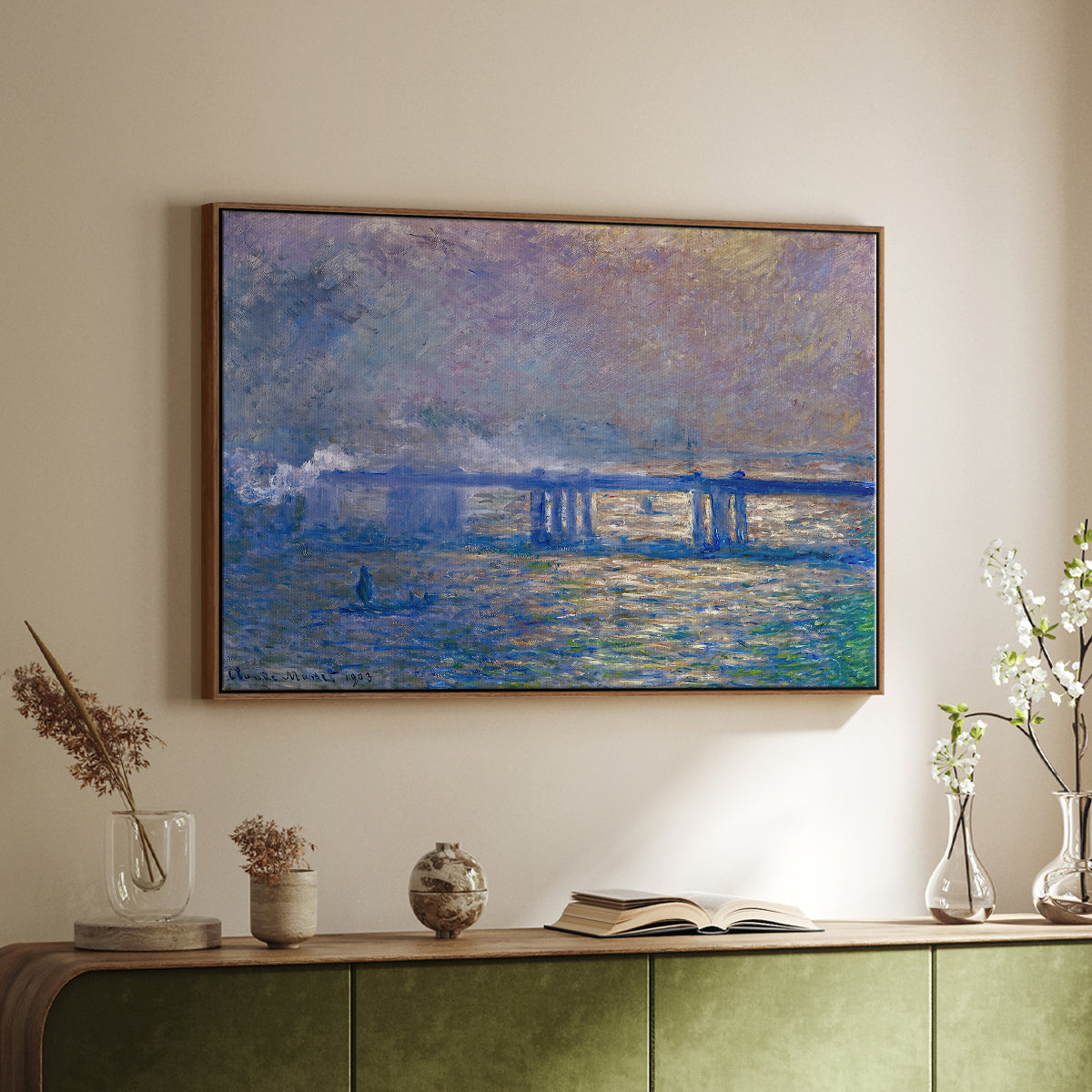 Walnut floater framed canvas of Charing Cross Bridge, 1903 by Claude Monet, featuring an urban landscape with bridge and water rendered in blurred tones above a sideboard in a softly lit hallway.