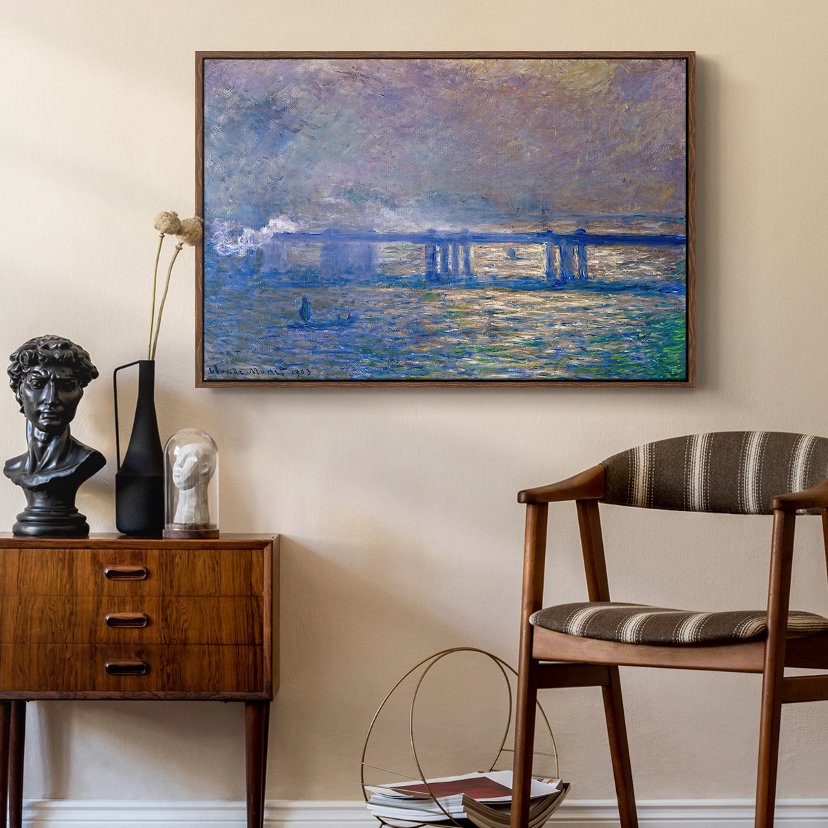 Charing Cross Bridge, 1903 by Claude Monet as a walnut floater framed canvas featuring an atmospheric depiction of London bridge with reflections in water, styled above a mid-century console in a contemporary living area.