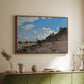 Walnut floater framed canvas of The Beach at Honfleur, 1864 by Claude Monet, featuring an impressionist seaside with people and sailboats under bright sky above a sideboard in a softly lit hallway.
