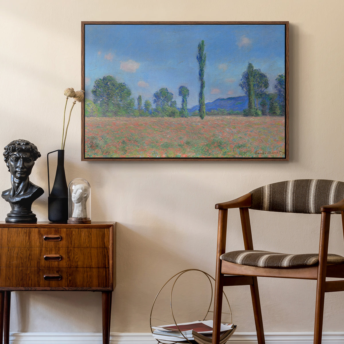 Poppy Field (Giverny), 1890-1891 by Claude Monet as a walnut floater framed canvas featuring a vibrant meadow scene with flowers and vertical tree forms, styled above a mid-century console in a contemporary living area.