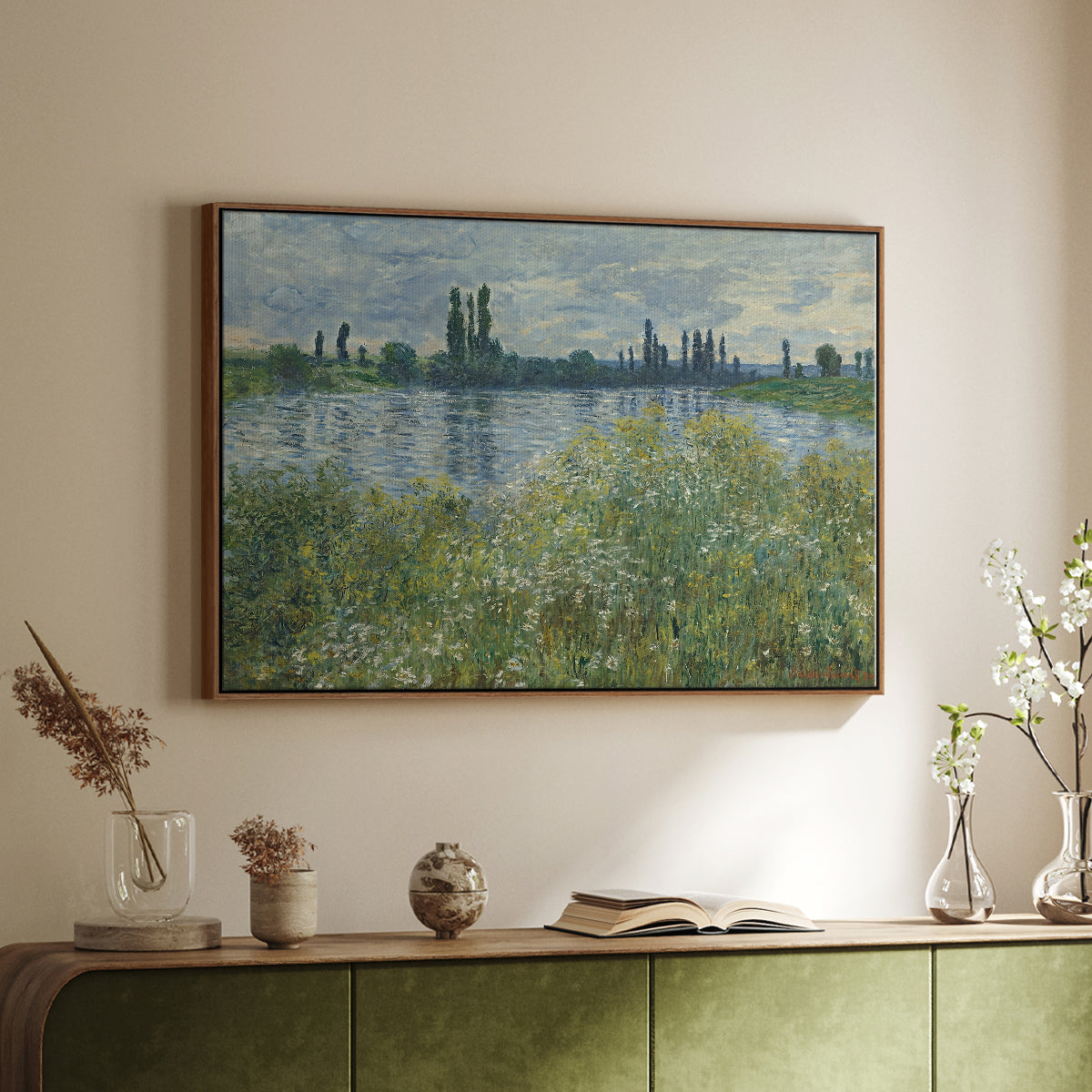 Walnut floater framed canvas of Banks of the Seine, Vétheuil, 1880 by Claude Monet, featuring an impressionist view of Seine with reflections and greenery above a sideboard in a softly lit hallway.