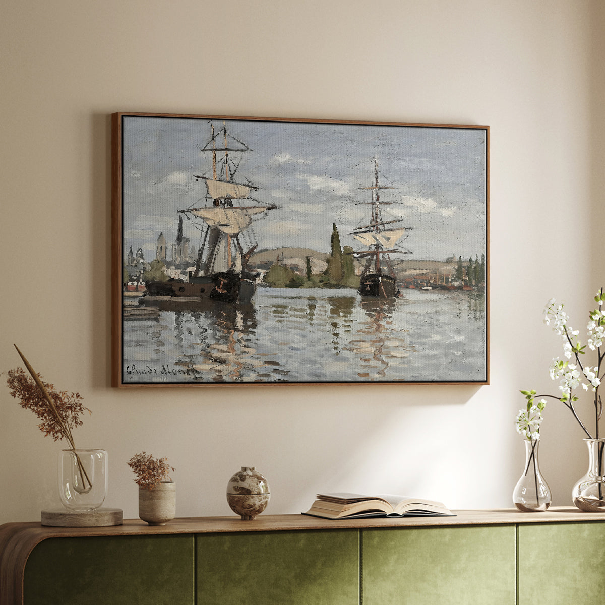 Walnut floater framed canvas of Ships Riding on the Seine at Rouen, 1872 by Claude Monet, featuring an impressionist river scene with anchored sailing ships and reflections above a sideboard in a softly lit hallway.
