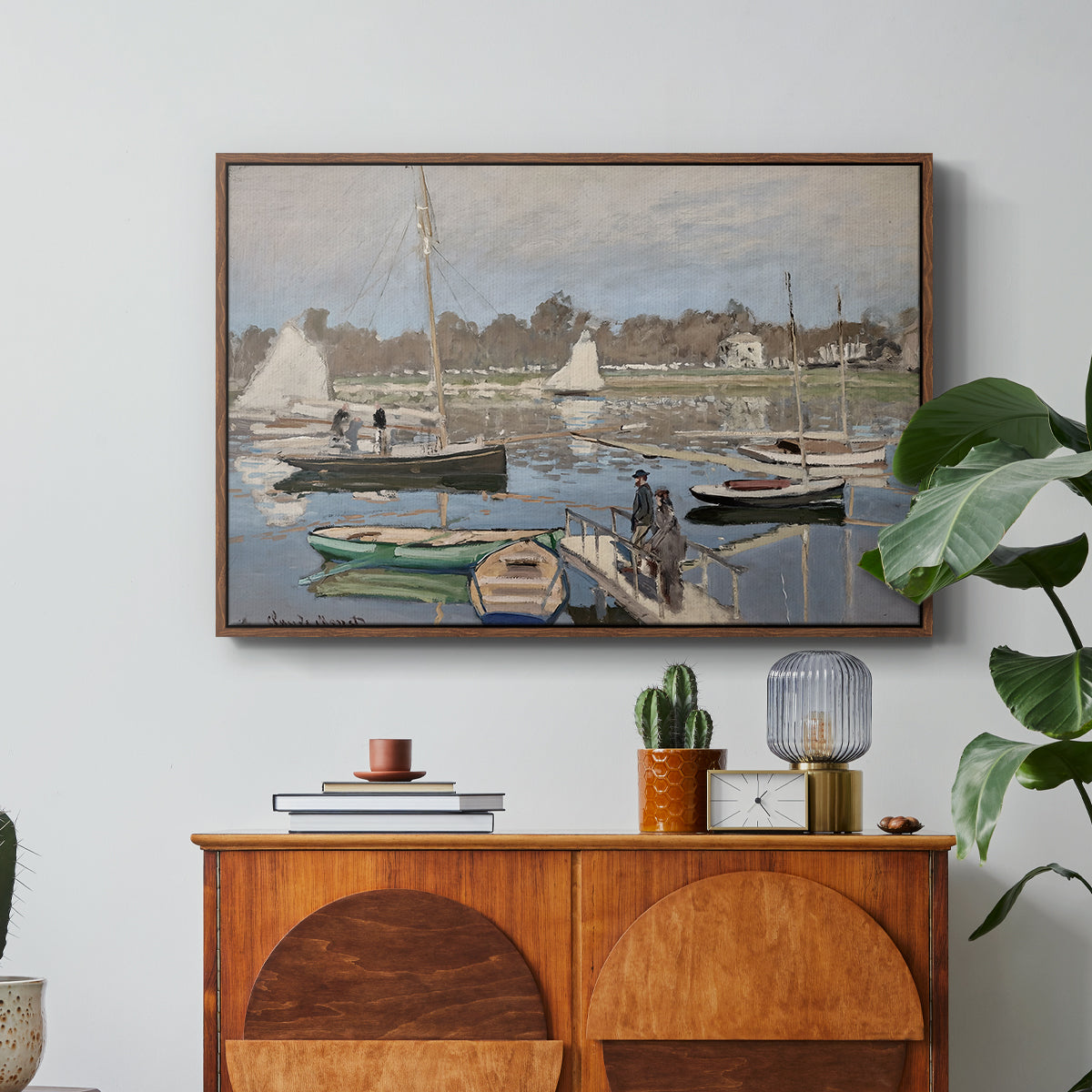 The Basin at Argenteuil, 1874 by Claude Monet in a walnut floater framed canvas featuring sailboats gathered in calm basin with reflections on water, displayed above a wood console cabinet.