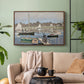 Walnut floater framed canvas featuring a tranquil river setting with sailboats and shoreline, displayed above a sofa in a modern living room.