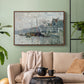 Walnut floater framed canvas featuring a harbor view with masts, houses, and reflections in water, displayed above a sofa in a modern living room.