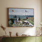 Walnut floater framed canvas of Garden at Sainte-Adresse, 1867 by Claude Monet, featuring an impressionist coastal garden with people and ocean view above a sideboard in a softly lit hallway.