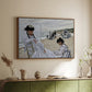 Walnut floater framed canvas of On the Beach at Trouville, 1870 by Claude Monet, featuring an impressionist seaside scene with women in dresses and hats above a sideboard in a softly lit hallway.