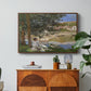 On the Bank of the Seine, Bennecourt, 1868 by Claude Monet in a walnut floater framed canvas featuring a woman and child seated along riverbank beneath trees in soft daylight, displayed above a wood console cabinet.