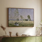 Walnut floater framed canvas of Summer (L'ete), 1874 by Claude Monet, featuring an impressionist countryside scene with figure resting in shade above a sideboard in a softly lit hallway.