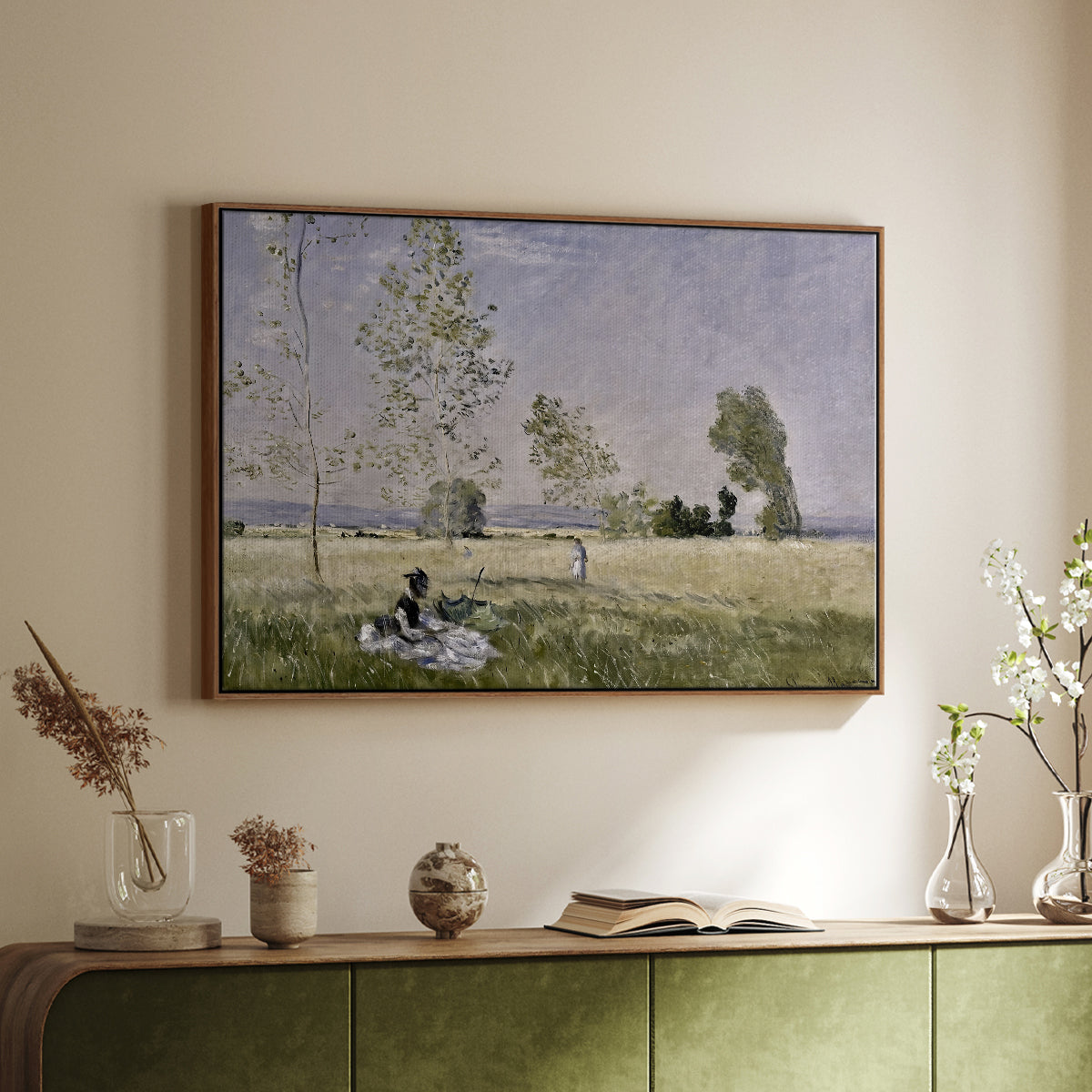Walnut floater framed canvas of Summer (L'ete), 1874 by Claude Monet, featuring an impressionist countryside scene with figure resting in shade above a sideboard in a softly lit hallway.