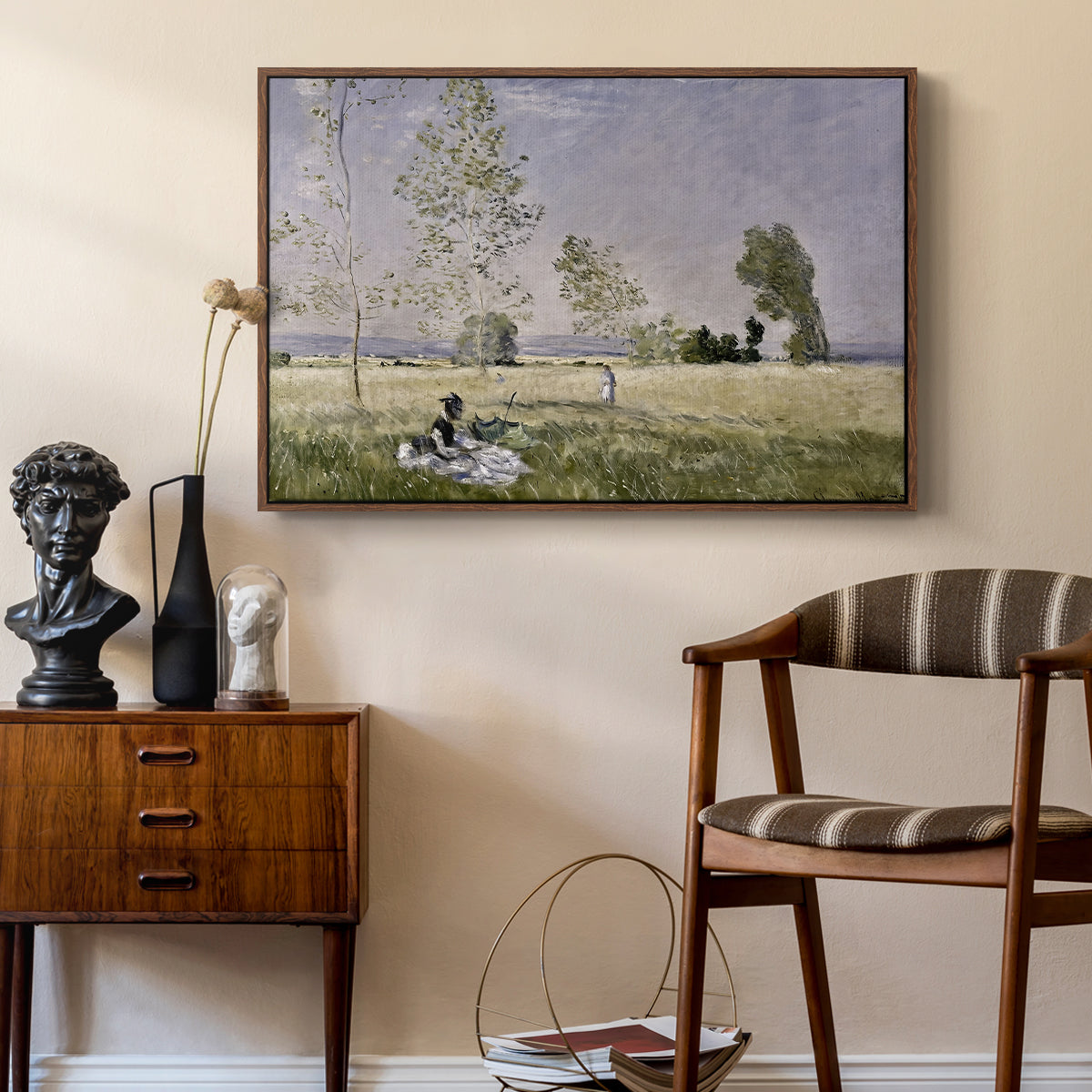 Summer (L'ete), 1874 by Claude Monet as a walnut floater framed canvas featuring a sunlit meadow with woman surrounded by greenery, styled above a mid-century console in a contemporary living area.