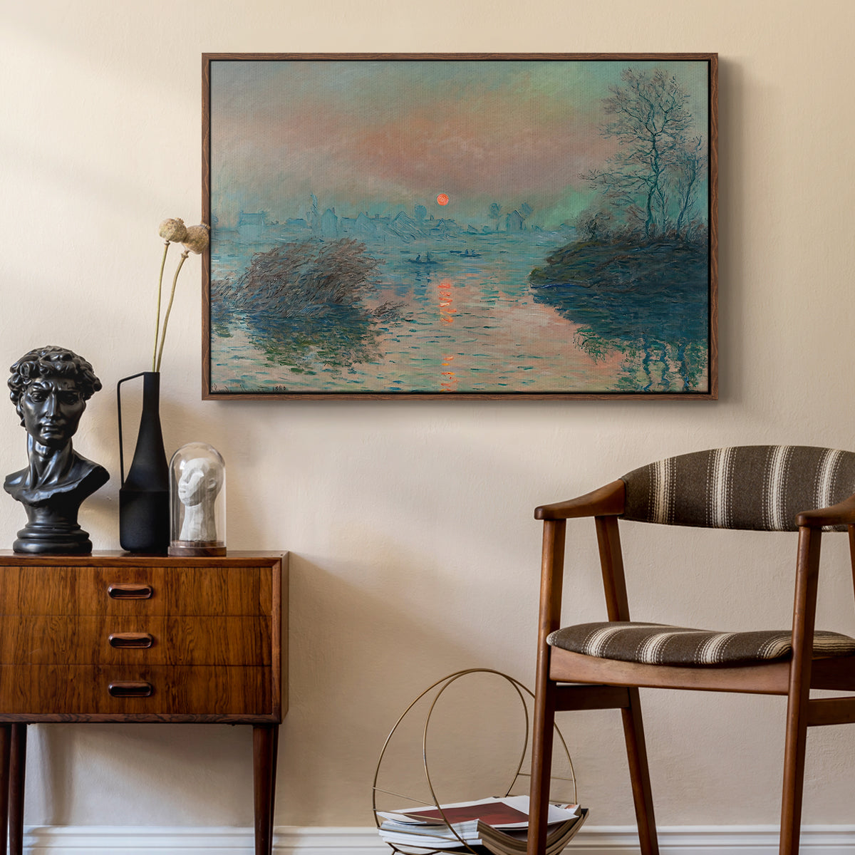 Sunset on the Seine at Lavacourt, Winter Effect, 1880 by Claude Monet as a walnut floater framed canvas featuring an impressionist view of river at sunset with snowy banks, styled above a mid-century console in a contemporary living area.