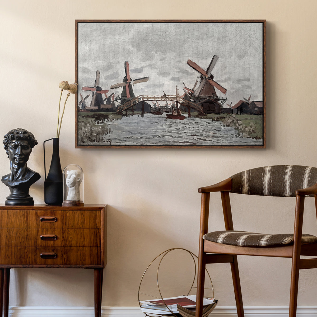 Windmills near Zaandam, 1871 by Claude Monet as a walnut floater framed canvas featuring a countryside scene with traditional windmills and reflections, styled above a mid-century console in a contemporary living area.