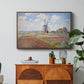 Tulip Fields with the Rijnsburg Windmill, 1886 by Claude Monet in a walnut floater framed canvas featuring colorful rows of tulip fields leading toward distant windmill, displayed above a wood console cabinet.