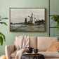 Walnut floater framed canvas featuring a countryside structure standing against open sky, displayed above a sofa in a modern living room.
