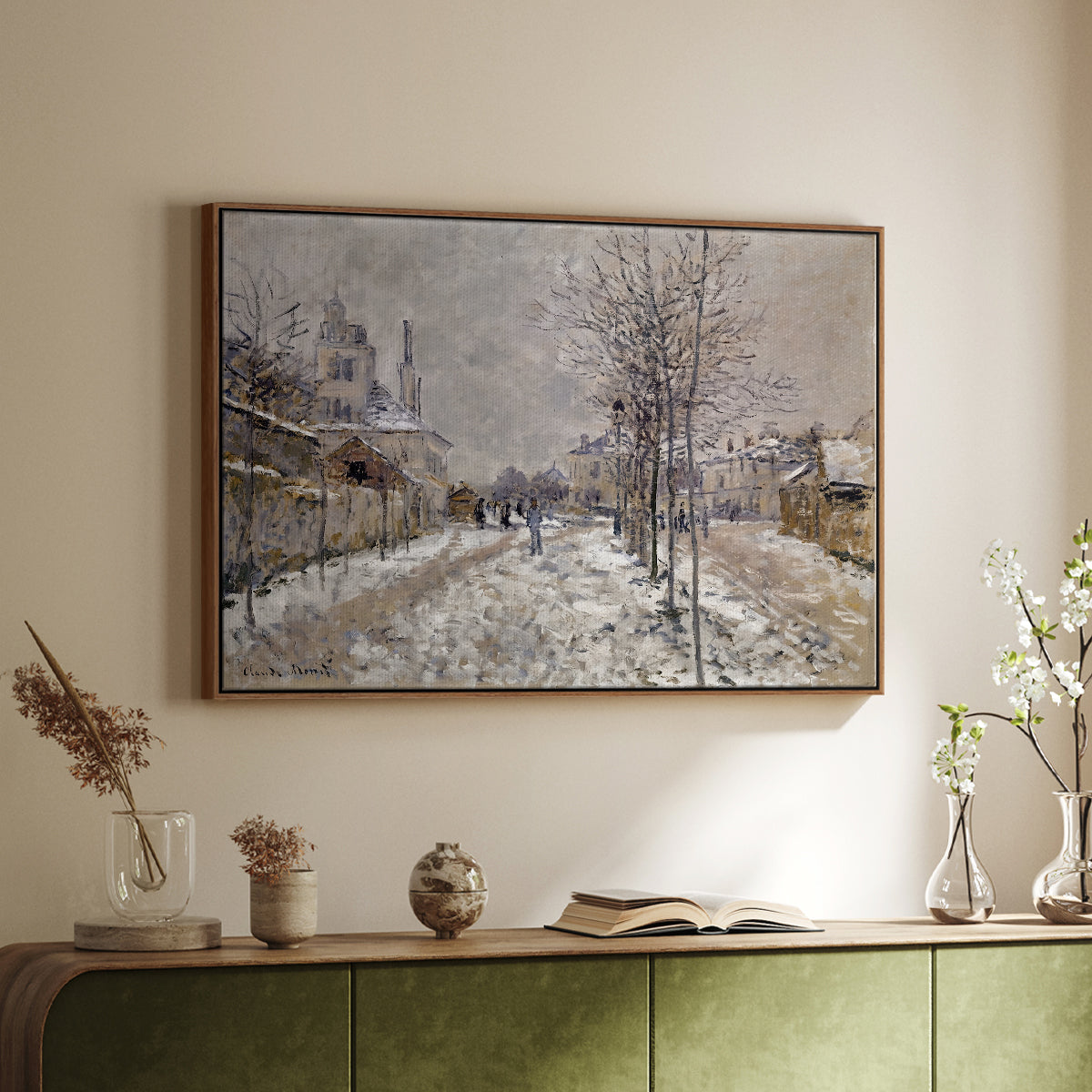 Walnut floater framed canvas of The Boulevard de Pontoise at Argenteuil, Snow Effect, 1875 by Claude Monet, featuring an impressionist winter scene with road and bare trees above a sideboard in a softly lit hallway.