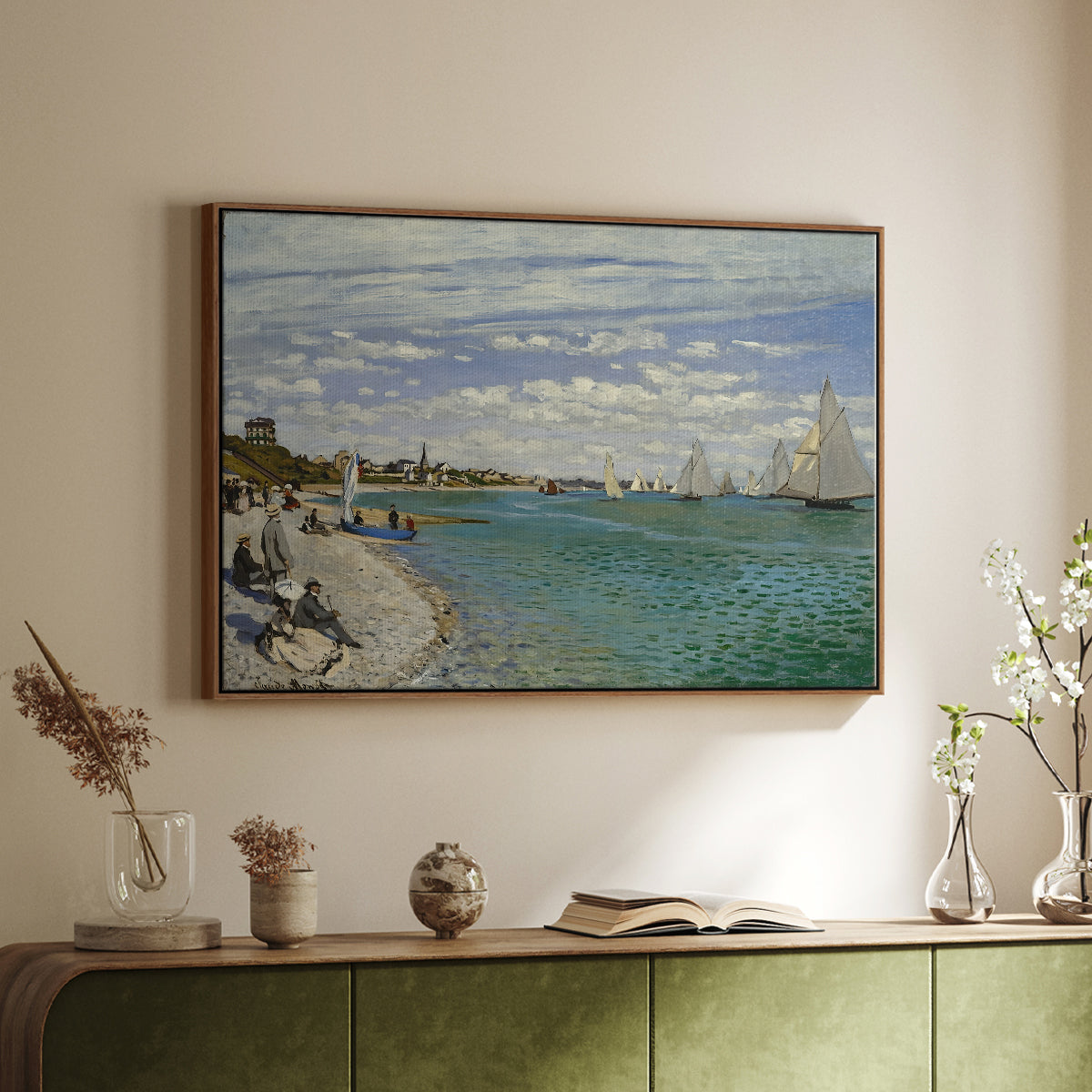 Walnut floater framed canvas of Regatta at Sainte-Adresse, 1867 by Claude Monet, featuring a lively regatta scene with boats and people on beach above a sideboard in a softly lit hallway.