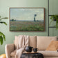 Walnut floater framed canvas featuring a natural field scene with vibrant red flowers, displayed above a sofa in a modern living room.
