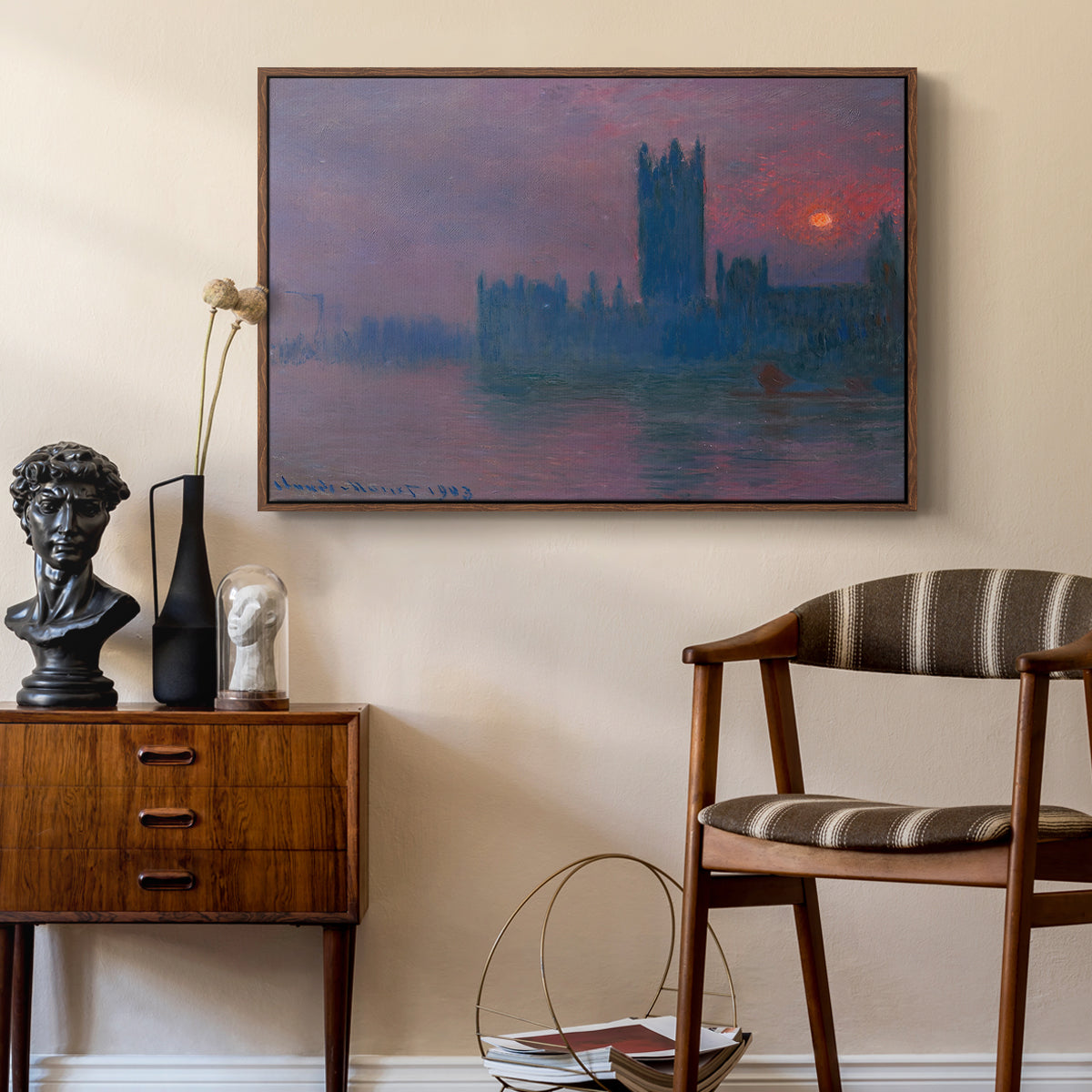 The Houses of Parliament, Sunset, 1903 by Claude Monet as a walnut floater framed canvas featuring an atmospheric London scene with buildings fading into haze, styled above a mid-century console in a contemporary living area.