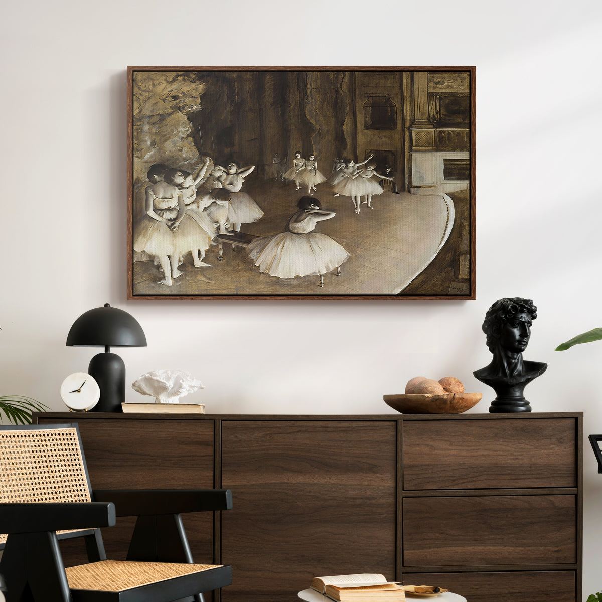 The Rehearsal of the Ballet Onstage, 1874 by Edgar Degas displayed in a walnut floater framed canvas above a dark wood credenza in an entryway.