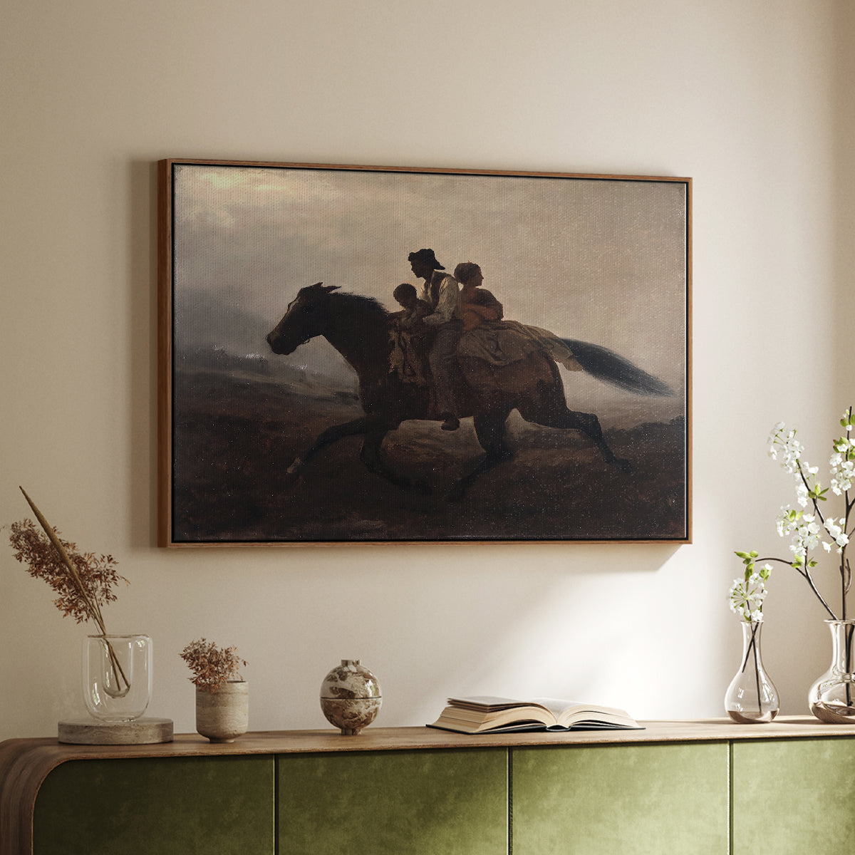 Walnut floater framed canvas of A Ride for Liberty – The Fugitive Slaves, c. 1862 by Eastman Johnson, featuring a dramatic scene of enslaved people fleeing on horseback in darkness above a sideboard in a softly lit hallway.