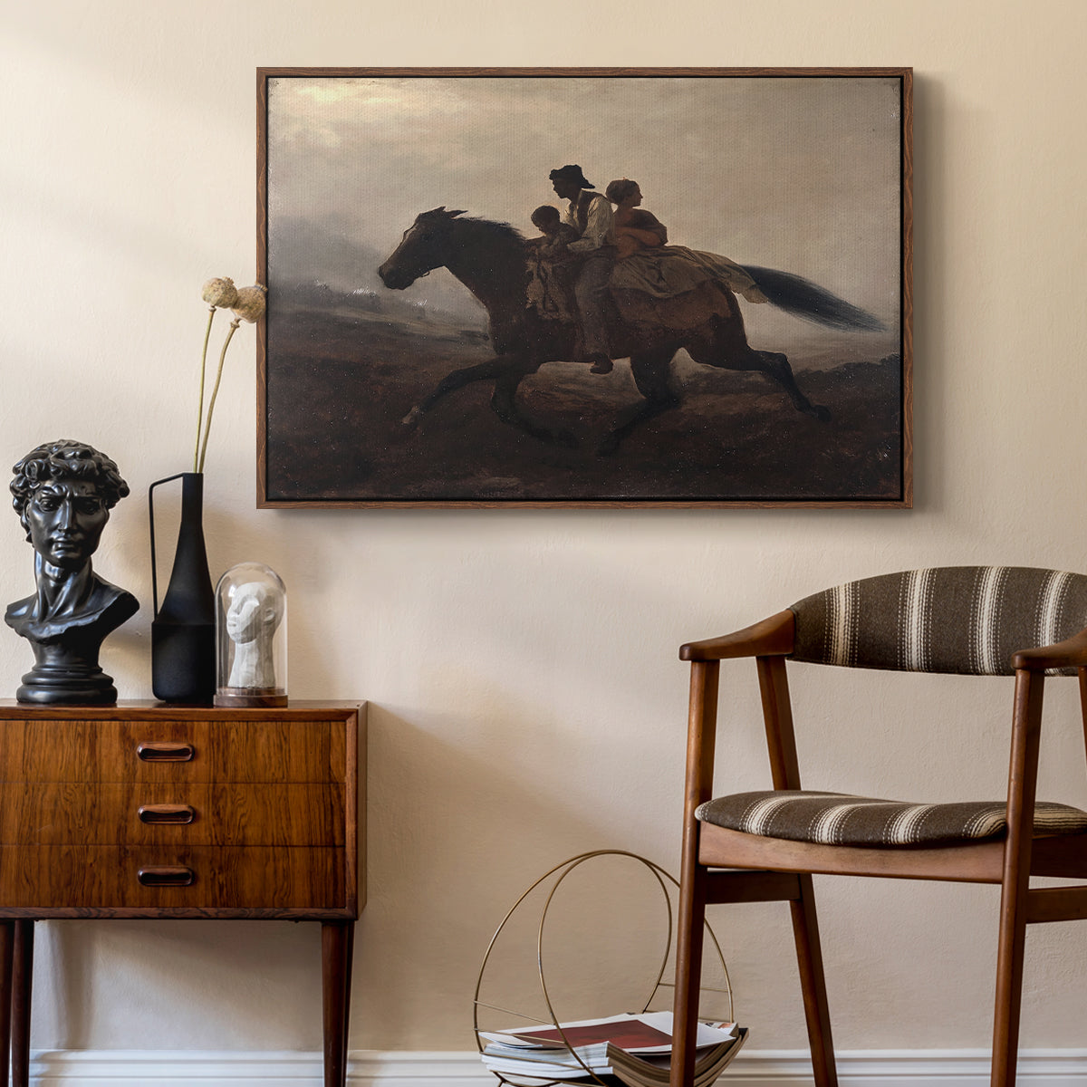 A Ride for Liberty – The Fugitive Slaves, c. 1862 by Eastman Johnson as a walnut floater framed canvas featuring a narrative painting of escape and urgency across rugged terrain, styled above a mid-century console in a contemporary living area.