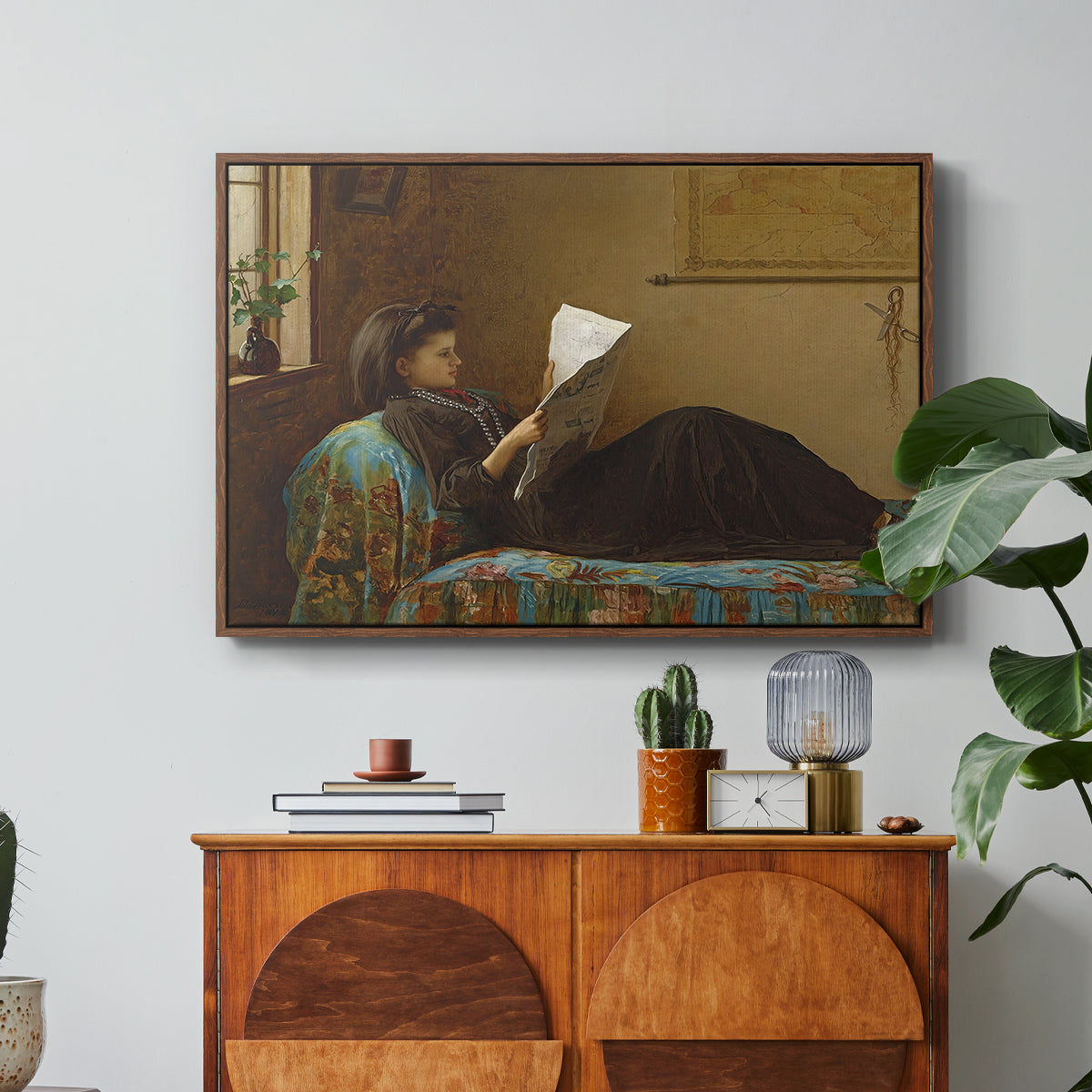 Interesting News, 1872 by Eastman Johnson in a walnut floater framed canvas featuring a group of people gathered indoors reading newspaper together, displayed above a wood console cabinet.