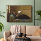 Walnut floater framed canvas featuring a casual gathering around newspaper in rustic room, displayed above a sofa in a modern living room.