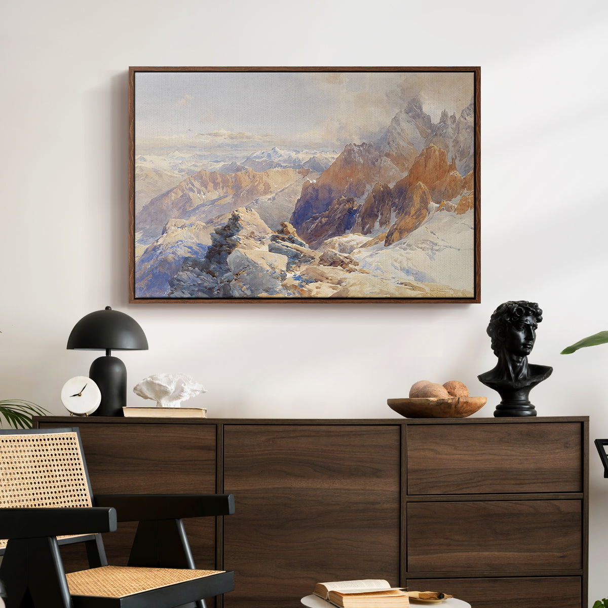 Col du Géant, 1903 by Edward Theodore Compton displayed in a walnut floater framed canvas above a dark wood credenza in an entryway.