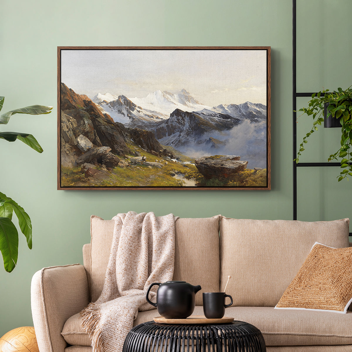 Walnut floater framed canvas featuring a scenic mountain view with dramatic elevation and depth, displayed above a sofa in a modern living room.