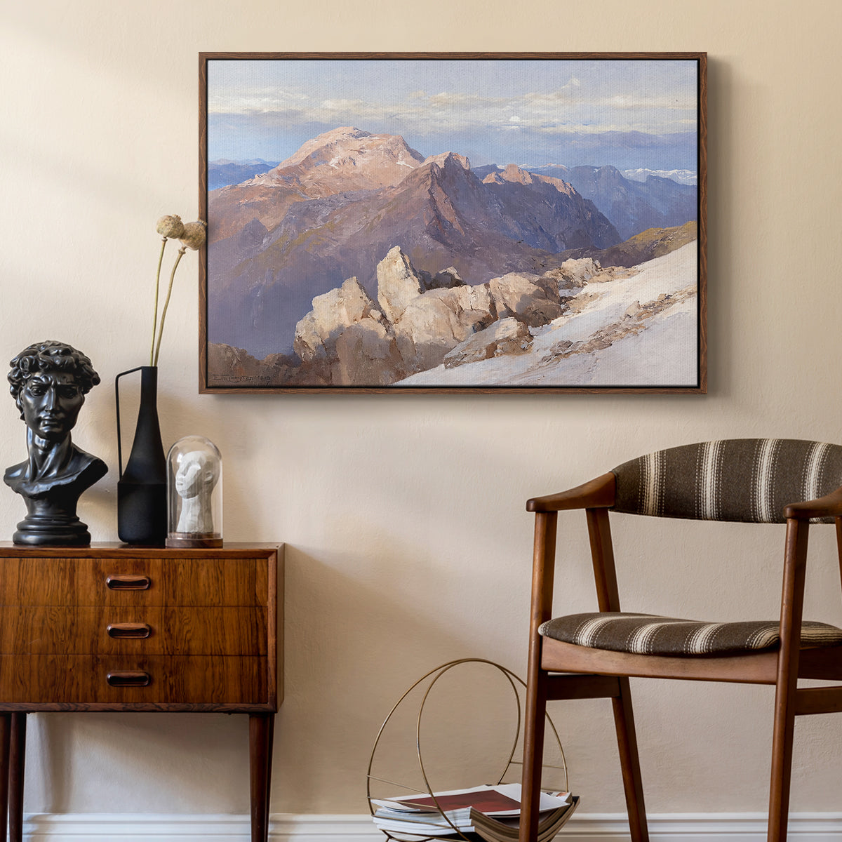 Hoher Göll from Watzmann-Hocheck, 1919 by Edward Theodore Compton as a walnut floater framed canvas featuring a high vantage point overlooking rugged mountain terrain, styled above a mid-century console in a contemporary living area.