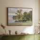 Walnut floater framed canvas of Landscape at Lake Starnberg, 1890 by Edward Theodore Compton, featuring a peaceful lake scene with reflections and surrounding greenery above a sideboard in a softly lit hallway.