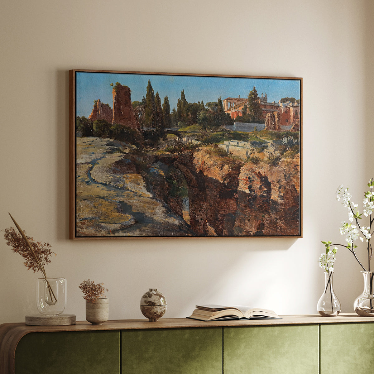 Walnut floater framed canvas of Palatine in Rome, c. 1921 by Edward Theodore Compton, featuring an architectural scene of ancient structures in sunlit environment above a sideboard in a softly lit hallway.