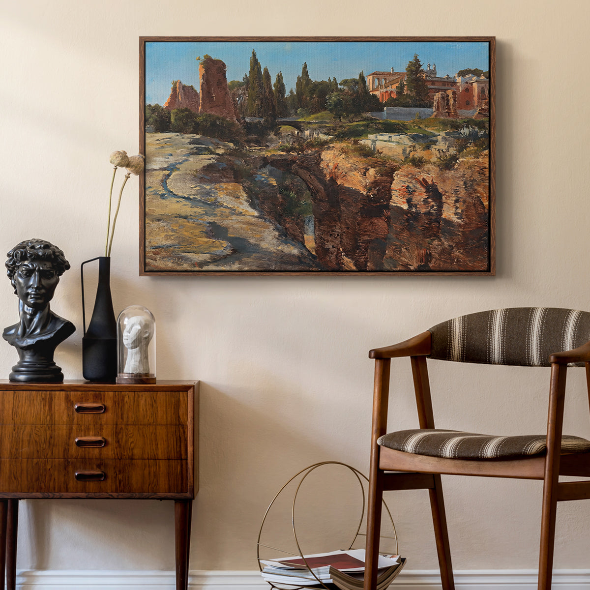 Palatine in Rome, c. 1921 by Edward Theodore Compton as a walnut floater framed canvas featuring a cityscape with classical ruins and surrounding terrain, styled above a mid-century console in a contemporary living area.