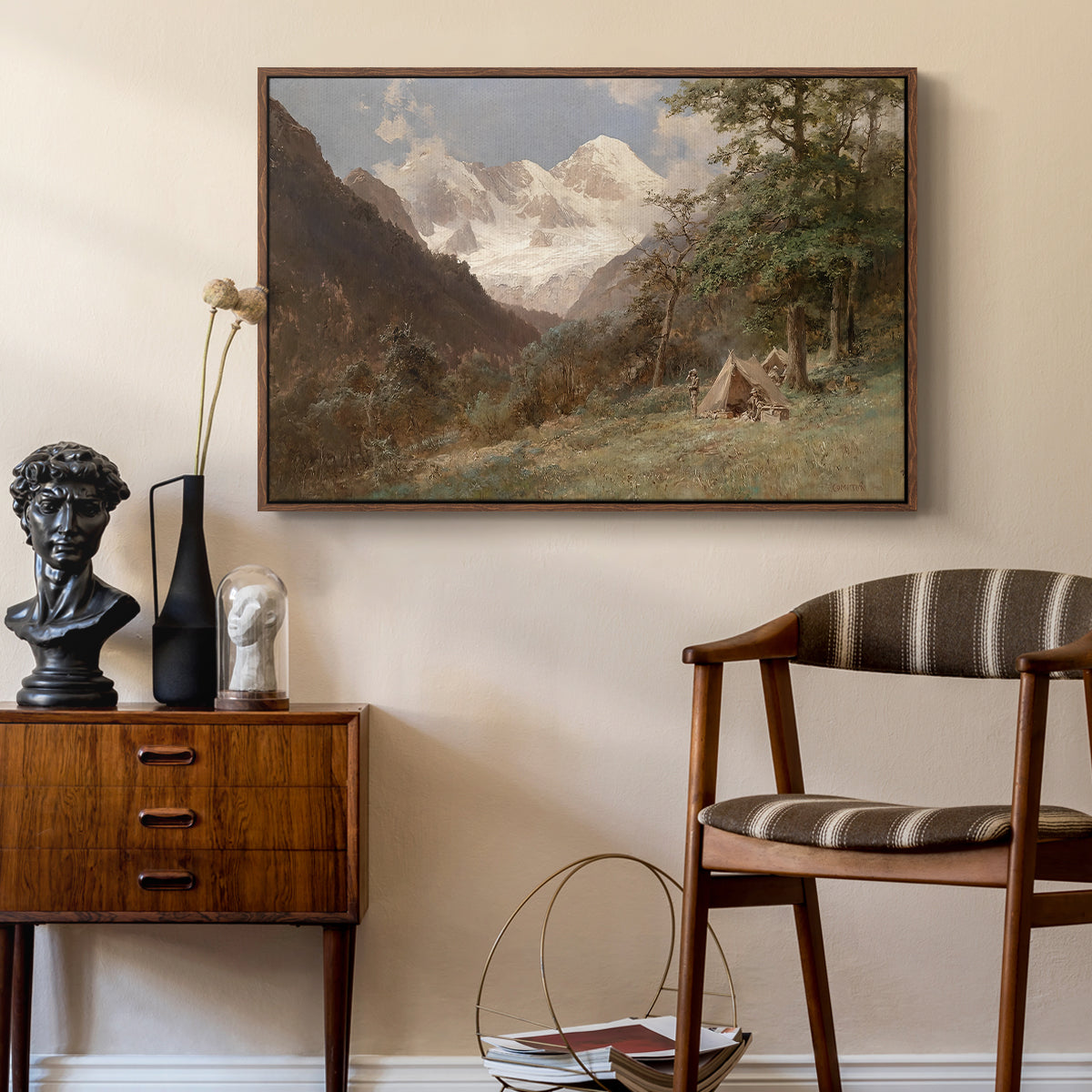 Landscape in the Caucasus, c. 1921 by Edward Theodore Compton as a walnut floater framed canvas featuring a natural scene with valleys and rocky formations, styled above a mid-century console in a contemporary living area.