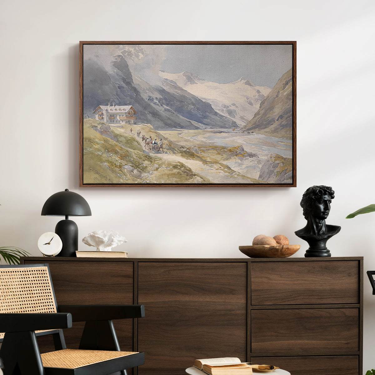 Shepherds (Pasterze), c. 1921 by Edward Theodore Compton displayed in a walnut floater framed canvas above a dark wood credenza in an entryway.