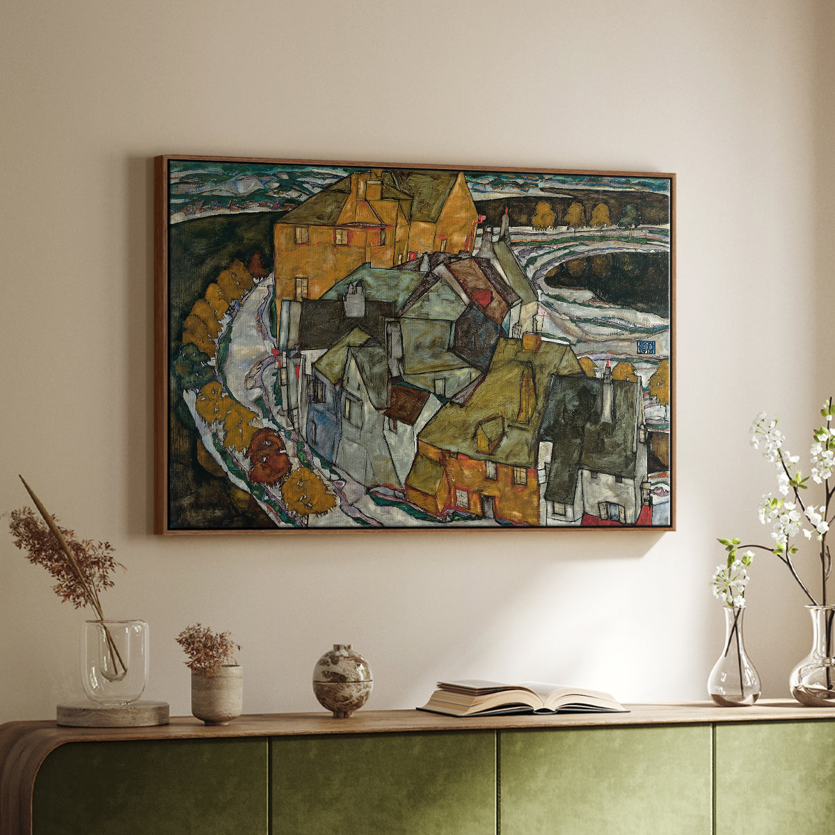 Walnut floater framed canvas of Crescent of Houses II (Island Town), 1915 by Egon Schiele, featuring a stylized townscape with clustered buildings and bold outlines above a sideboard in a softly lit hallway.
