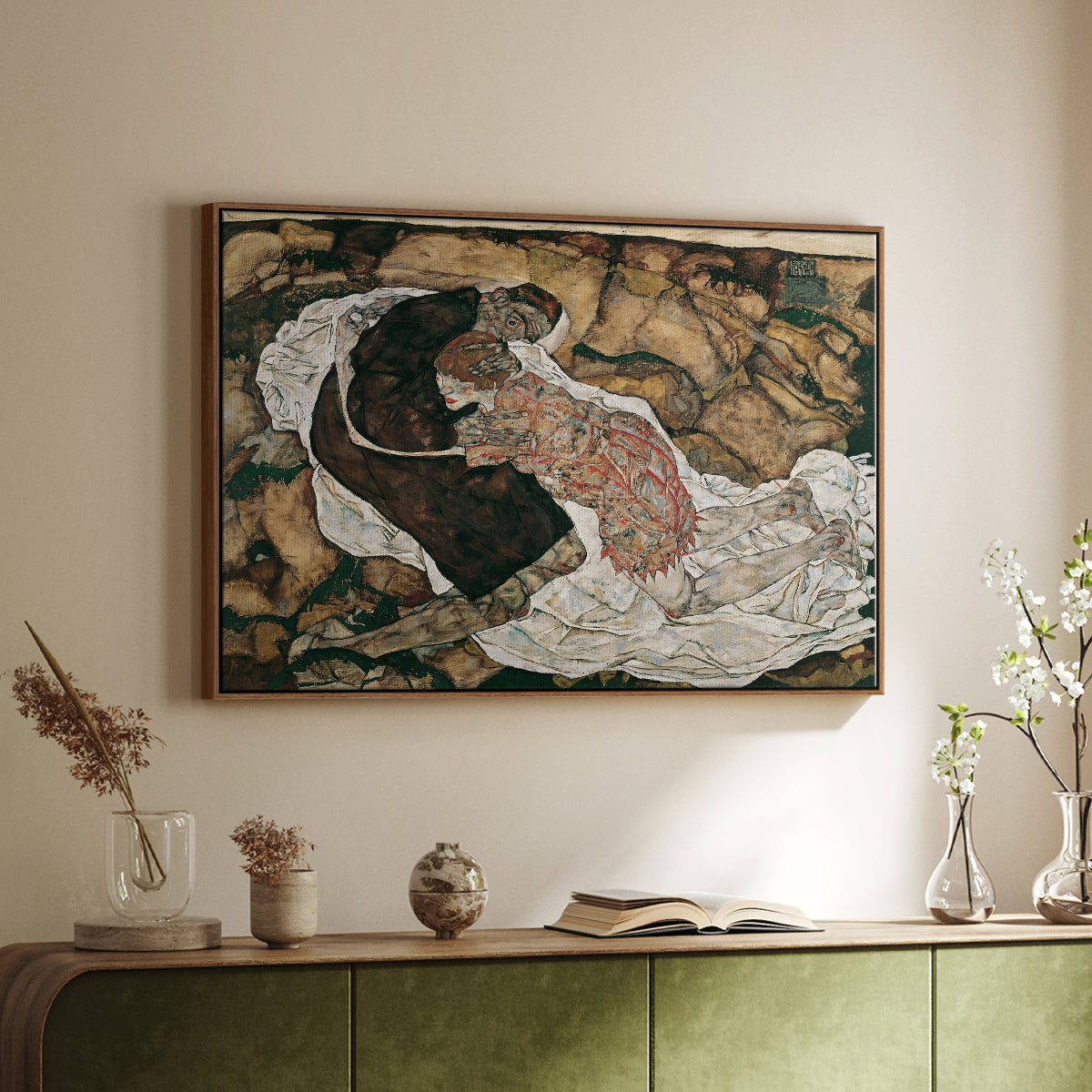 Walnut floater framed canvas of Death and the Maiden, 1915 by Egon Schiele, featuring a symbolic scene of mortality with two figures clinging together above a sideboard in a softly lit hallway.