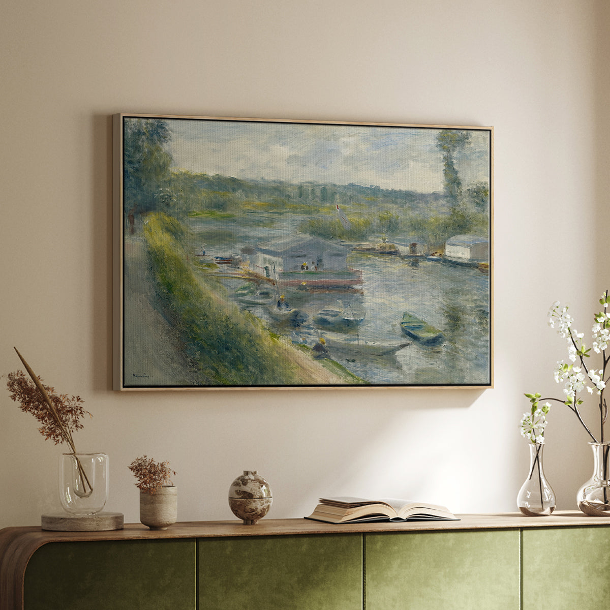 Natural wood floater framed canvas of Wash-House Boat at Bas-Meudon, c. 1874 by Pierre-Auguste Renoir, featuring a riverside scene with moored boat used for washing clothes above a sideboard in a softly lit hallway.
