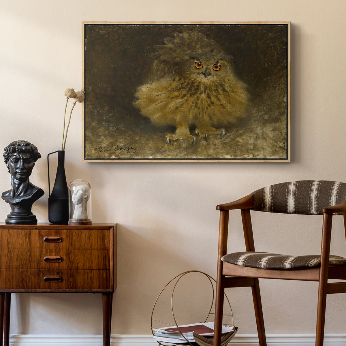 An Eagle Owl (Berguv), 1905 by Bruno Liljefors as a natural wood floater framed canvas featuring a bird of prey resting on tree branch with textured feathers, styled above a mid-century console in a contemporary living area.