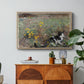 Cat on a Flowery Meadow, 1887 by Bruno Liljefors in a natural wood floater framed canvas featuring a cat crouching in a meadow filled with wildflowers and greenery, displayed above a wood console cabinet.